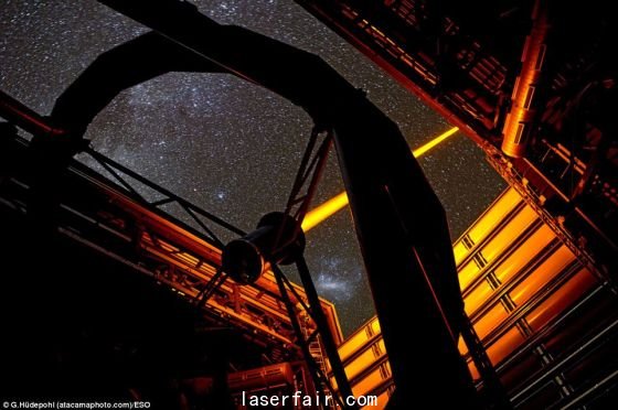 智利歐洲南方天文臺(tái)帕拉納爾天文臺(tái)操作的這個(gè)新PARLA激光器。從圖上可以看到，7瓦特激光器發(fā)出的橙黃色光束從甚大望遠(yuǎn)鏡的望遠(yuǎn)鏡4的穹隆結(jié)構(gòu)射向高空。在背景圖上還能看到大麥哲倫云